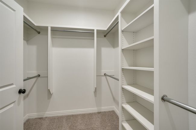 Walk in closet with carpet floors | Image 19