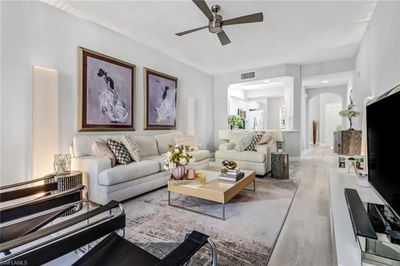 Living room with light hardwood / wood-style floors and ceiling fan | Image 2