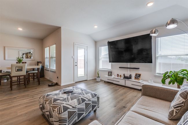 Living room featuring vaulted ceiling, light wood-style flooring, recessed lighting, and a healthy amount of sunlight | Image 9