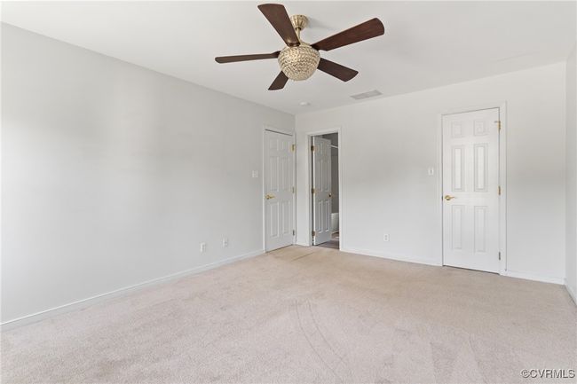 Empty room with light colored carpet and a ceiling fan | Image 19