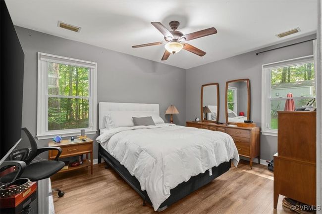Bedroom featuring multiple windows, light wood-style floors, and ceiling fan | Image 22