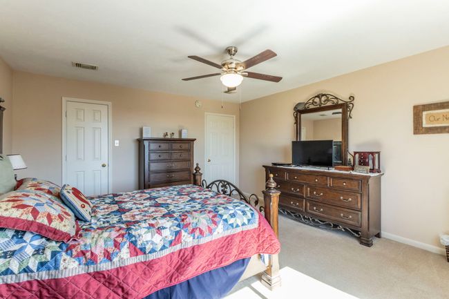 Carpeted bedroom featuring a ceiling fan and baseboards | Image 20