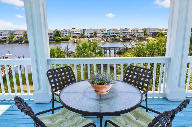 Wooden deck featuring a water view, a residential view, and outdoor dining space | Image 14