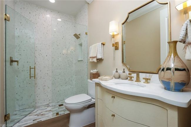 Bathroom with a shower stall, vanity, and wood finished floors | Image 13