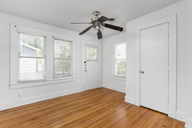 Entryway with light wood-style floors, baseboards, and ceiling fan | Image 32