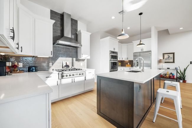 The gourmet kitchen features a built-in electric oven, impressive gas cooktop providing a professional culinary experience with high performance and timeless style | Image 7