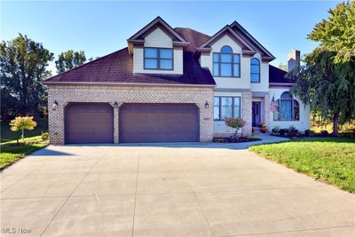 View of front of house with a garage and a front lawn | Image 2