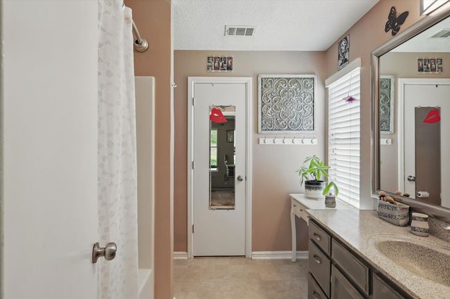 Bathroom featuring plenty of natural light, visible vents, and vanity | Image 26