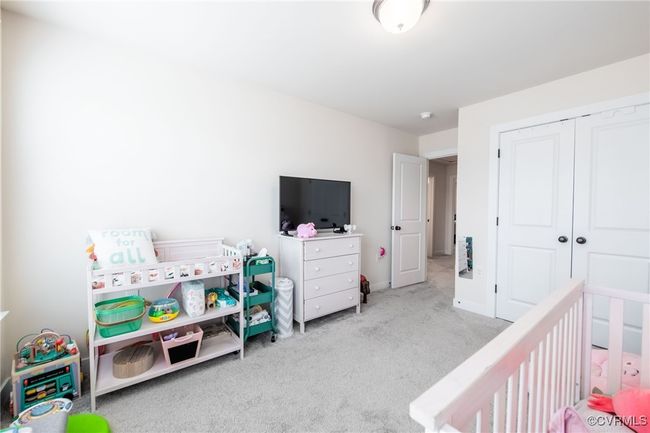 Carpeted bedroom with a closet and baseboards | Image 23