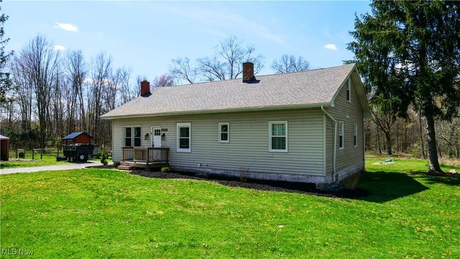 Rear view of property featuring a lawn and a chimney | Image 23
