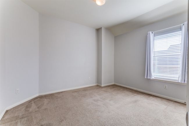 Unfurnished room featuring carpet floors and vaulted ceiling | Image 25