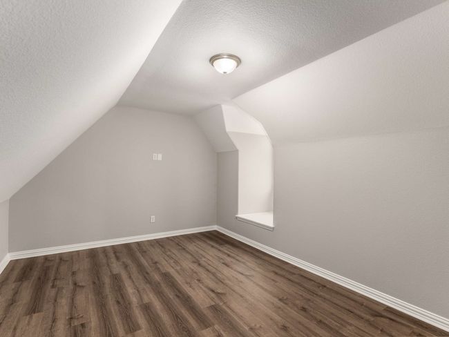 Additional living space with baseboards, a textured ceiling, lofted ceiling, and dark wood finished floors | Image 37