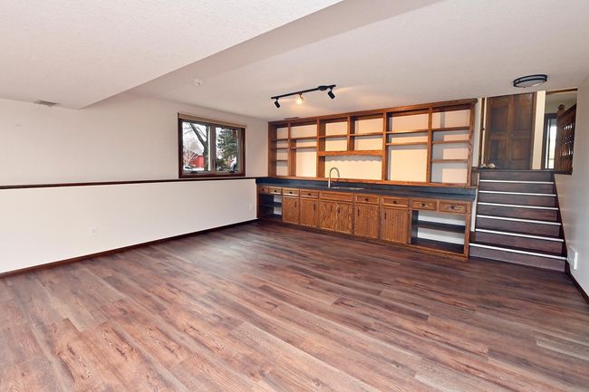 Freshly Painted Walk-Out Amusement/Family Room on 3rd Features Gas Fireplace and New LVP Flooring! Bar Features New Countertop, Sink and Faucet. | Image 26