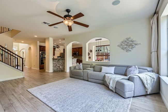 Open-concept layout connecting living, kitchen, and dining. | Image 5