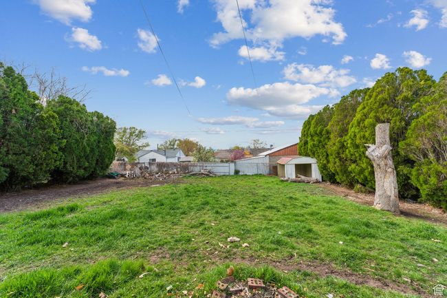 View of yard with an outdoor structure and fence | Image 30
