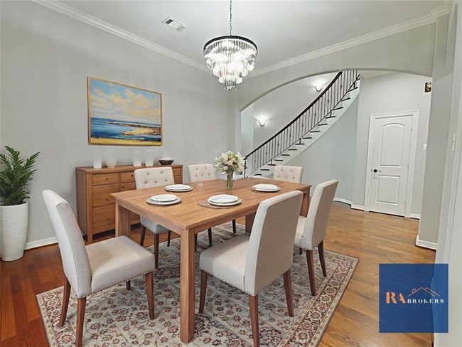 Elegant formal dining room with chandelier located just off the kitchen. (virtually staged) | Image 10