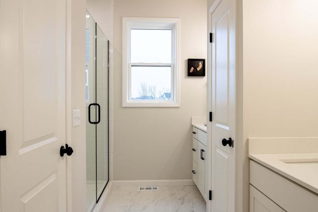 The primary bathroom includes a spacious walk-in shower, designed for both luxury and functionality. Photos are from previously built home; options and features will vary. | Image 19