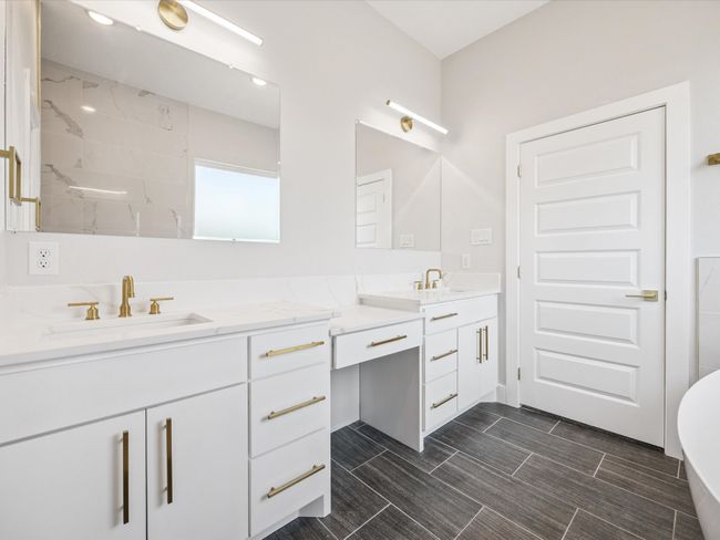 Full bath with double vanity, a soaking tub, and a shower | Image 18