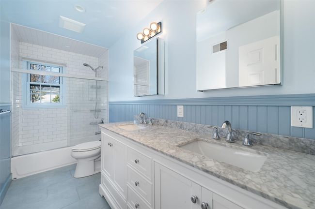 Recently renovated hall bathroom with wainscoting, double vanity | Image 26