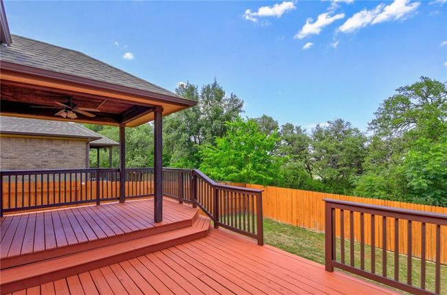 Deck with a fenced backyard and a ceiling fan | Image 31