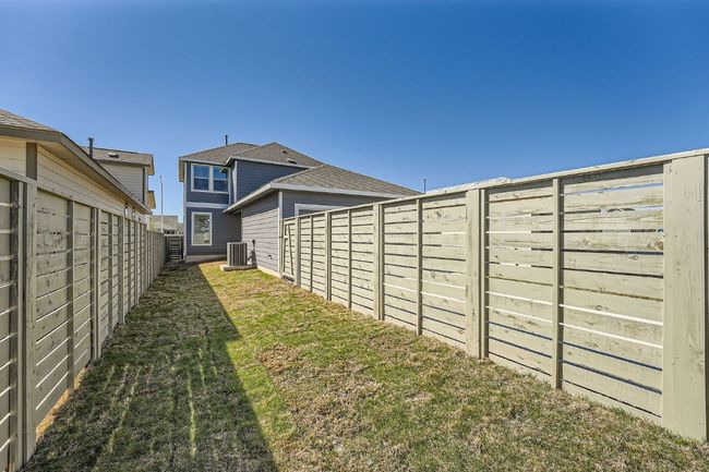 View of yard featuring central AC and a fenced backyard | Image 26