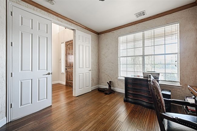 Office space with ornamental molding, dark wood-style flooring, visible vents, and baseboards | Image 6