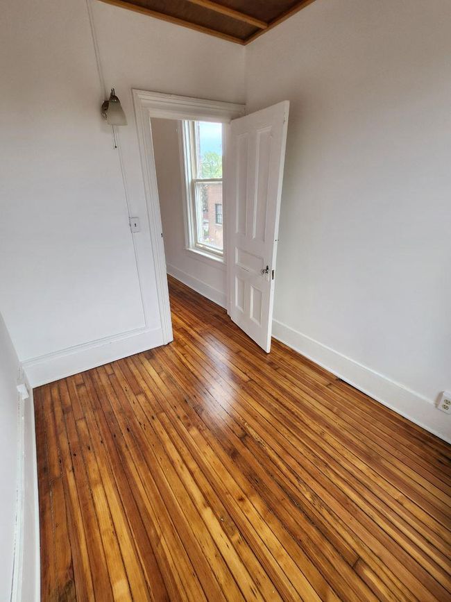 Spare room with hardwood / wood-style floors and baseboards | Image 9