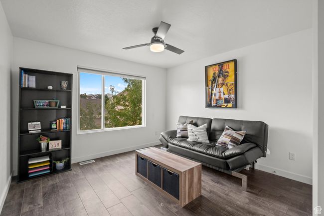 Living room featuring dark wood-style flooring and ceiling fan | Image 34