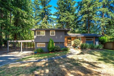 Charming midcentury modern front entry nestled among the lush trees of Squak Mountain. | Image 1