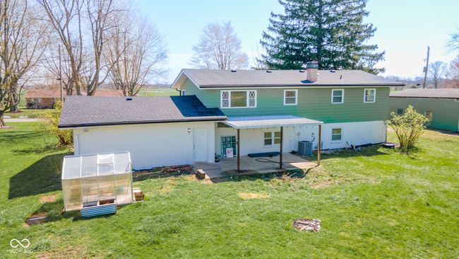 back of property with cooling unit, a yard, a patio area, and a greenhouse | Image 38