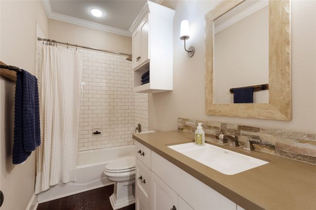 Full bath featuring toilet, crown molding, vanity, and shower / bathtub combination with curtain | Image 12