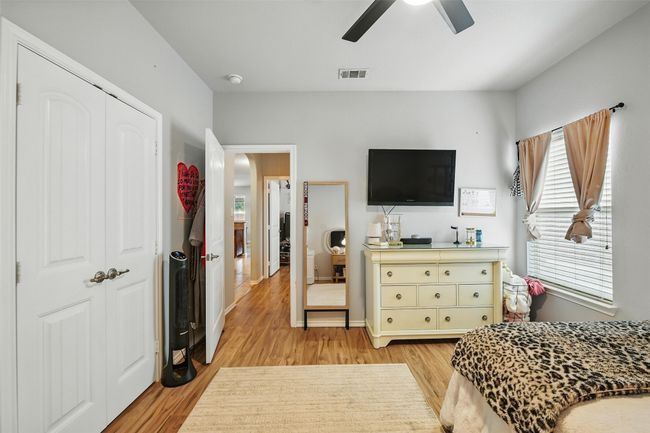 Bedroom with light wood finished floors, a ceiling fan, and a closet | Image 34