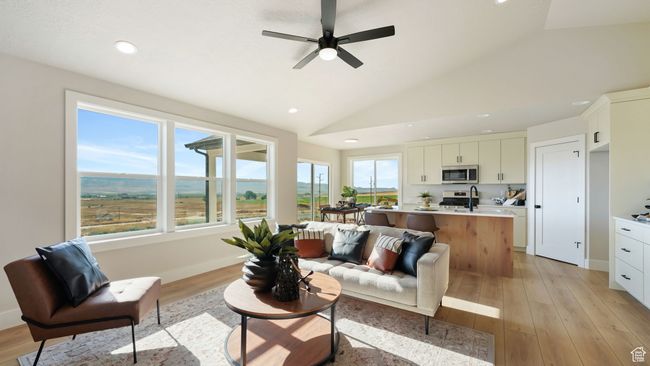 Living area with recessed lighting, vaulted ceiling, ceiling fan, and light wood-style floors | Image 6
