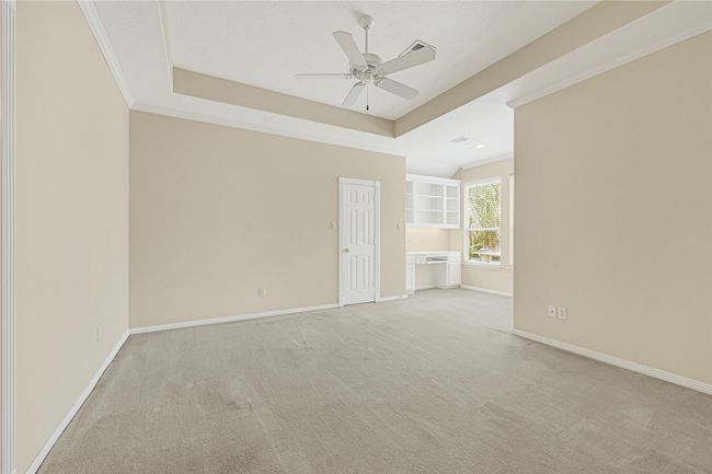 Inviting bedroom featuring a built-in desk and expansive walk-in closet. | Image 43