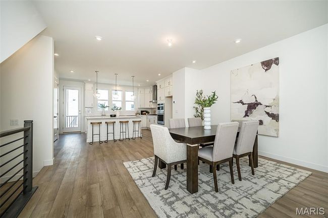 Dining area featuring light wood-style flooring and recessed lighting | Image 12
