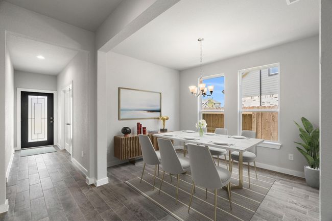 *Virtually Staged* Create lasting memories gathered around the table with family and friends in this spacious dining room. Enhanced by elegant flooring and custom paint, its adjacent to the family room and kitchen, fostering an open-concept atmosphere for shared moments. | Image 11