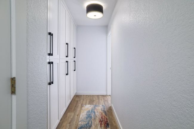 Hallway to guest bedrooms with lots of storage. | Image 17