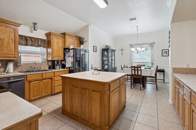 Roomy kitchen with large island, plenty of cabinetry, and counterspace | Image 9