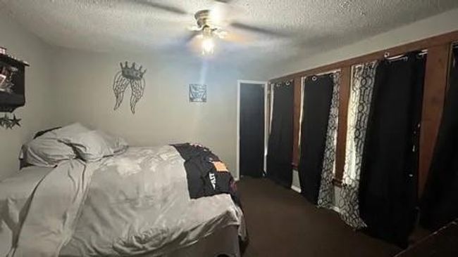 Bedroom with carpet, a textured ceiling, and ceiling fan | Image 20