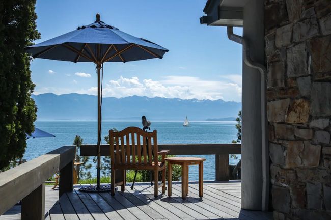Wooden deck featuring a water and mountain view | Image 10