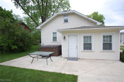 Rear view of house with a patio area and a hot tub | Image 3