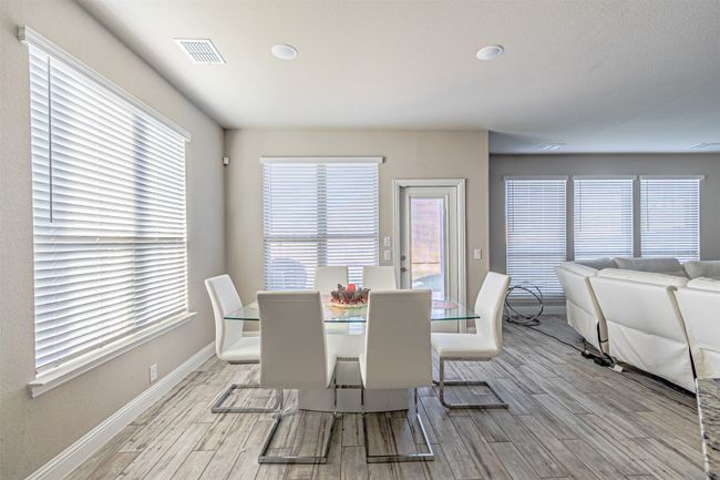 Dining area with light wood-type flooring, baseboards, plenty of natural light, and recessed lighting | Image 12