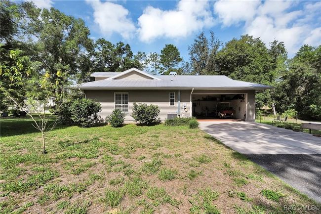 Side of home showing metal roof, side-entry garage | Image 25