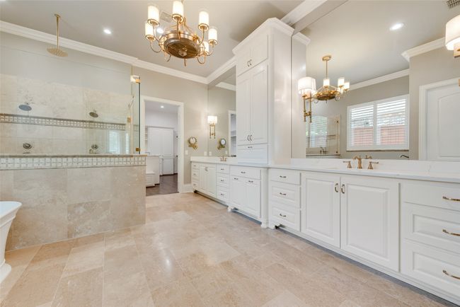 Full bathroom with vanity, a notable chandelier, a walk in shower, and crown molding | Image 24