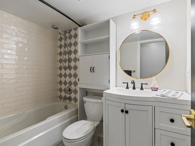 Bathroom with toilet, vanity, and bathtub / shower combination | Image 17