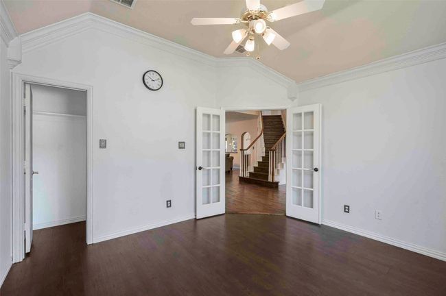 Unfurnished bedroom with visible vents, baseboards, ornamental molding, french doors, and wood finished floors | Image 10