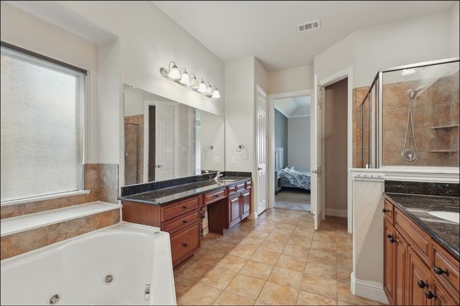 Bedroom featuring carpet flooring, crown molding, a raised ceiling, and a ceiling fan | Image 23