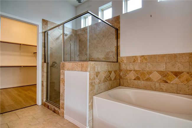 Bathroom featuring tile patterned flooring, a walk in closet, a garden tub, and a shower stall | Image 18