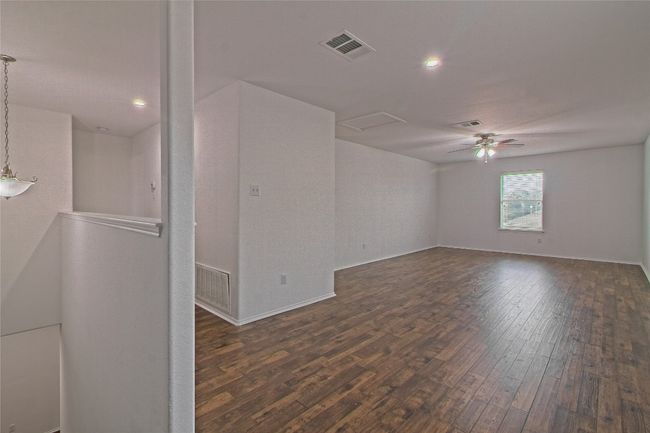 Unfurnished room with dark wood finished floors, attic access, ceiling fan, and recessed lighting | Image 21