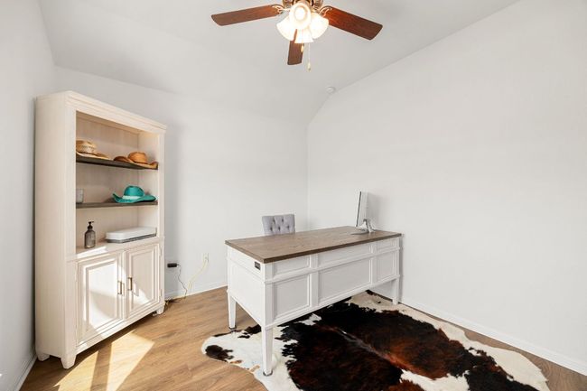 Home office featuring ceiling fan, lofted ceiling, and light wood-type flooring | Image 18